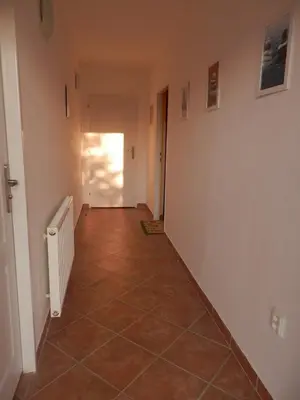 an empty hallway with a tile floor and a door at Apartment Boroví in Karlštejn