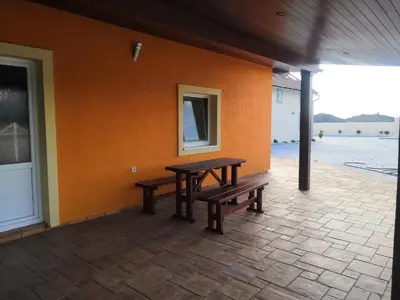 a picnic table and benches on a patio at Vehlovice Apartments in Mělník