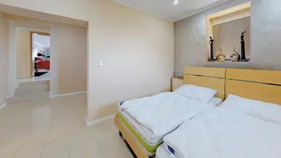 a bedroom with a bed and a window and a staircase at Vehlovice Apartments in Mělník