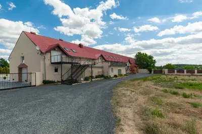 a house with a red roof on a gravel road at Vehlovice Apartments in Mělník