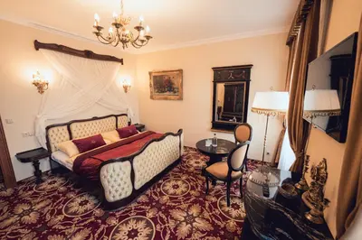 a bedroom with a bed and a chandelier at Hotel Svatojánský Dvůr in Prague
