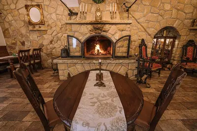 a dining room with a table and a fireplace at Hotel Svatojánský Dvůr in Prague