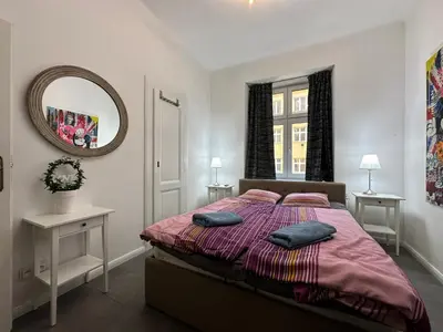 a bedroom with a bed with two pillows on it at Karlin Oasis 2-Bedroom Apartment in Prague