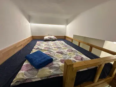 a small bedroom with a bed in the corner at Karlin Oasis 2-Bedroom Apartment in Prague