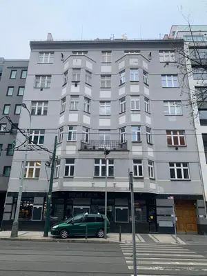 a green van parked in front of a large building at Karlin Oasis 2-Bedroom Apartment in Prague