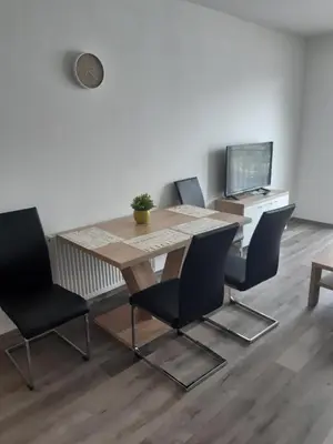 a dining room table and chairs in a room at Apartmán Karolína in Poděbrady