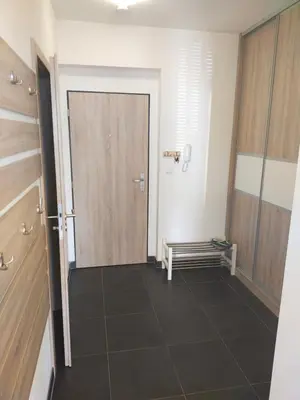 a hallway with a door and a tiled floor at Apartmán Karolína in Poděbrady