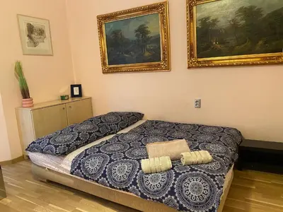 a bedroom with a bed and two pictures on the wall at Super Old Town in Prague