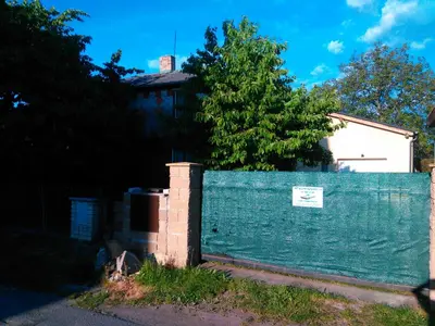 a blue fence in front of a house at Old Summer House with renovated bathroom in Prague