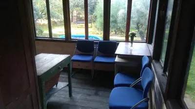 a room with chairs and a table and windows at Old Summer House with renovated bathroom in Prague