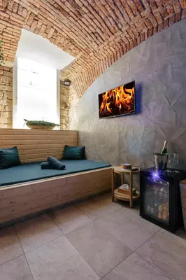 a living room with a couch and a fireplace at Wellness Hostel Central in Prague