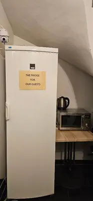 a white refrigerator in a kitchen with a sign on it at Historic Centre Residence in Prague