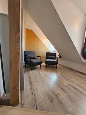 two chairs and a couch in a room with an attic at Historic Centre Residence in Prague