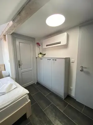 a room with a bed and a white room with a door at Historic Centre Residence in Prague