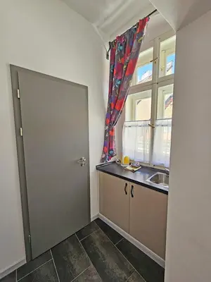 a kitchen with a door and a sink and a window at Historic Centre Residence in Prague