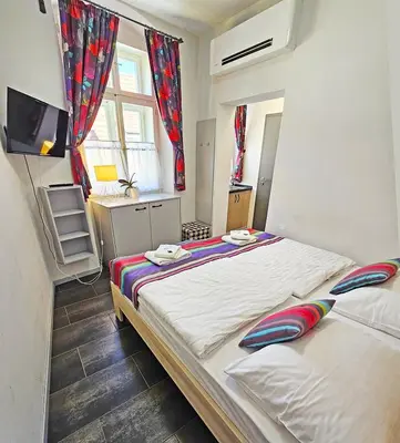 a bedroom with two beds and a television in it at Historic Centre Residence in Prague