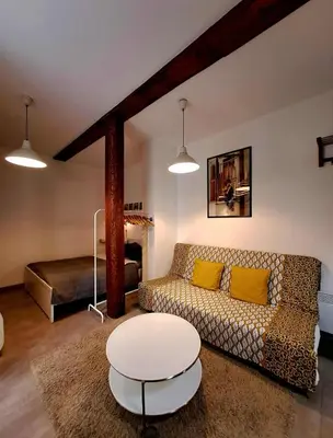 a living room with a couch and a table and a bed at Magnificent apartment in the center of Prague in Prague