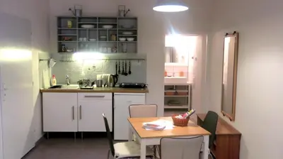 a kitchen with a table and a table and chairs at Magnificent apartment in the center of Prague in Prague