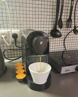 a coffee maker is making a cup of coffee at Magnificent apartment in the center of Prague in Prague
