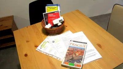 a table with a basket of books and a magazine at Magnificent apartment in the center of Prague in Prague