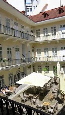 a large building with tables and chairs and an umbrella at Magnificent apartment in the center of Prague in Prague