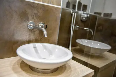 a bathroom with a white sink and a shower at Quiet & new apartment near city center with garage in Prague