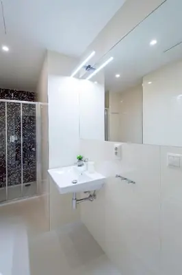 a white bathroom with a sink and a shower at Modern apartment Pricna 4 in Prague