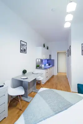 a white bedroom with a desk and a bed at Modern apartment Pricna 4 in Prague