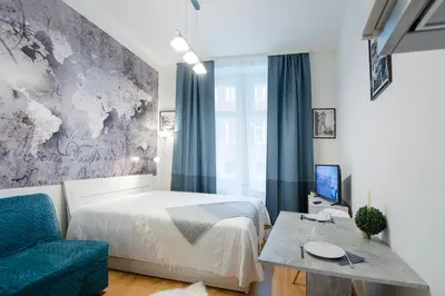 a bedroom with a bed and a table and a couch at Modern apartment Pricna 4 in Prague