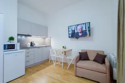 a kitchen and a living room with a couch and a table at Modern apartment Pricna 4 in Prague