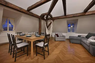 a living room with a wooden table and chairs at White Swan Boutique Apartments in Prague