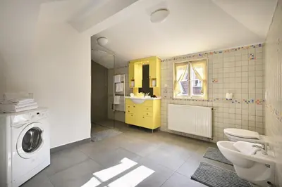 a bathroom with a sink and a washing machine at White Swan Boutique Apartments in Prague