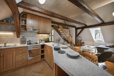 a large kitchen with wooden cabinets and a kitchen island at White Swan Boutique Apartments in Prague