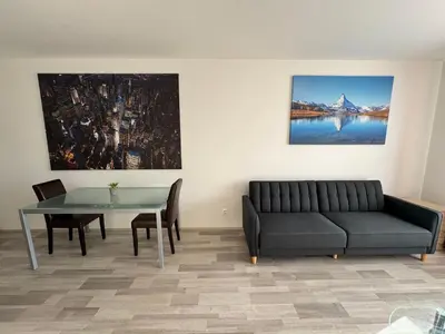 a living room with a couch and a table at Spacious 2BR with balcony in Prague - Comfort & Style in Prague