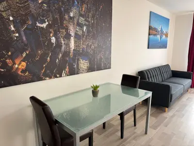 a living room with a glass table and a couch at Spacious 2BR with balcony in Prague - Comfort & Style in Prague