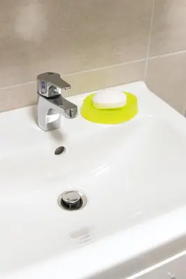 a sink with a yellow lid and a faucet at Spacious 2BR with balcony in Prague - Comfort & Style in Prague