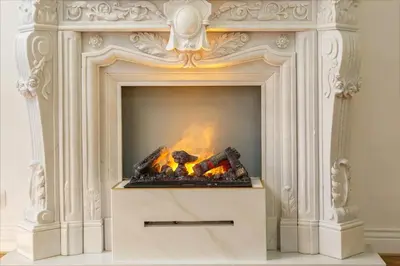 a white fireplace with a fire in it at Palace Apartment by Main Station - President in Prague