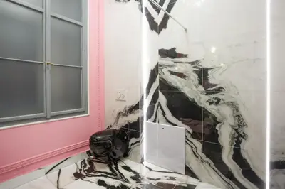 a room with a marble wall with a mirror at Palace Apartment by Main Station - President in Prague