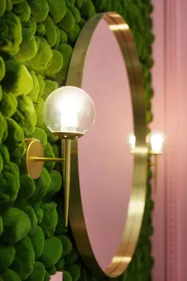 a mirror on a wall next to a lamp at Palace Apartment by Main Station - President in Prague