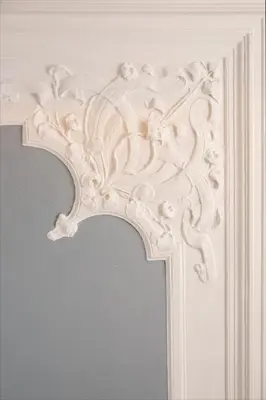 a white door frame with a carving on it at Palace Apartment by Main Station - President in Prague