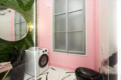 a bathroom with a washing machine and a mirror at Palace Apartment by Main Station - President in Prague