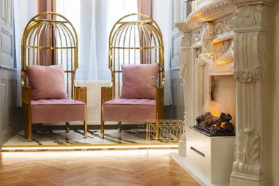 two chairs in a room with a fireplace at Palace Apartment by Main Station - President in Prague