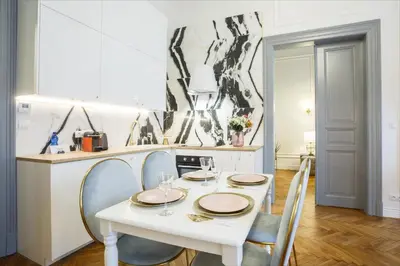 a white dining room with a white table and chairs at Palace Apartment by Main Station - Premier in Prague