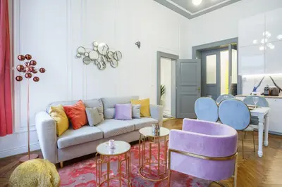 a living room with a couch and some chairs at Palace Apartment by Main Station - Premier in Prague