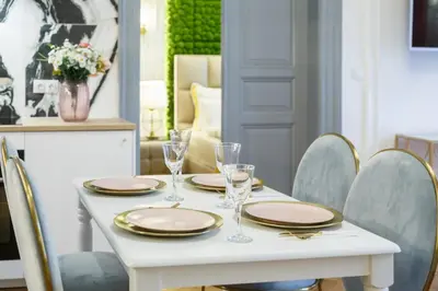 a white table with plates and glasses on it at Palace Apartment by Main Station - Premier in Prague