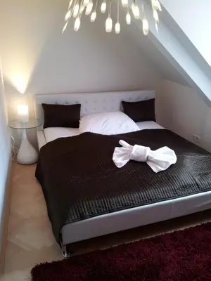 a bedroom with a bed with a bow tie on it at Selinor Old Town Apartments in Prague