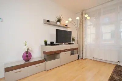 a living room with a flat screen tv on a wall at Selinor Old Town Apartments in Prague