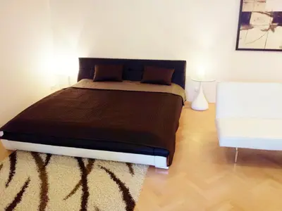 a bedroom with a large bed and a white couch at Selinor Old Town Apartments in Prague