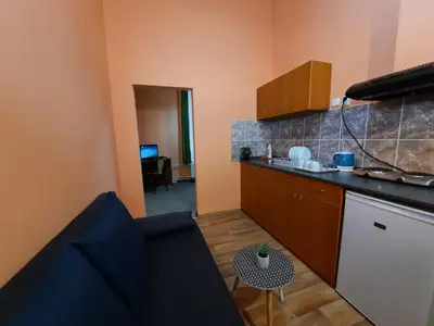a small kitchen with a counter and a table at Pension City Center in Prague