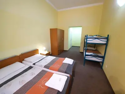 a small room with two beds and a bunk bed at Pension City Center in Prague